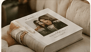 A bound photo keepsake book resting on a sofa
